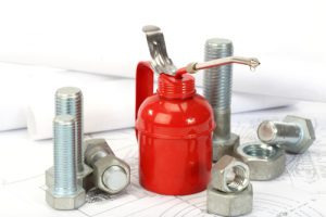 Close up of a red oiler, bolts and nuts
